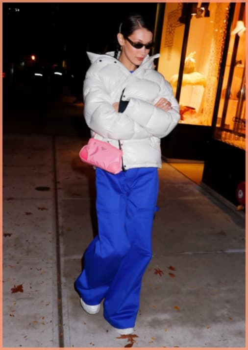 Bella-Hadid-white-down-jacket-rose-prada-bag-blue-owersized-pants
